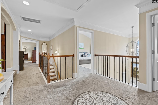 hall featuring ornamental molding, carpet, visible vents, and an upstairs landing