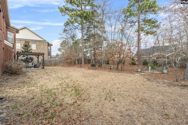 view of yard featuring a patio area, a fenced backyard, and a pergola