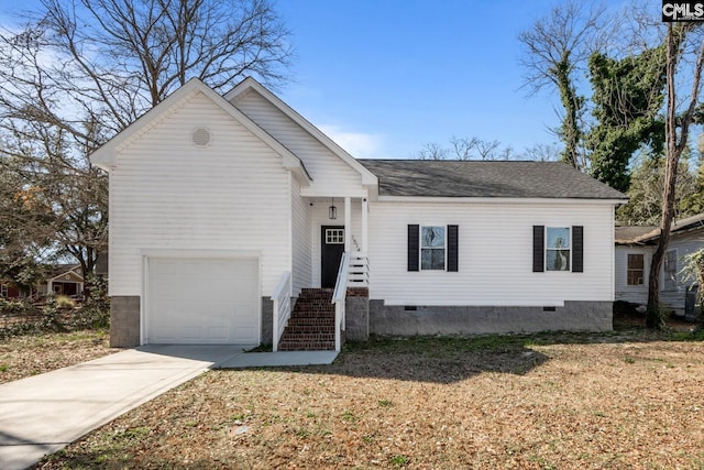 view of front of property with concrete driveway, a shingled roof, crawl space, and an attached garage