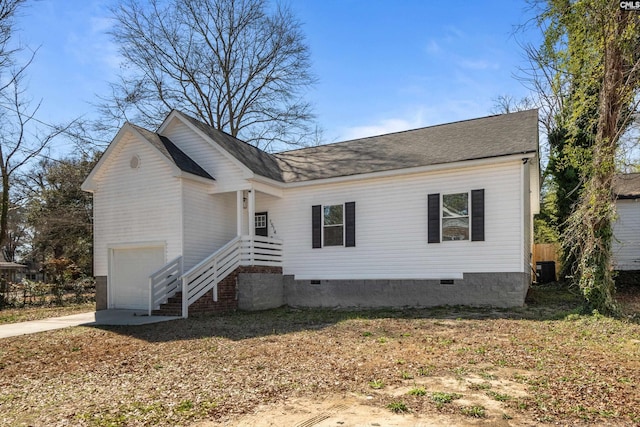 view of front of property with a garage, crawl space, central AC, and driveway