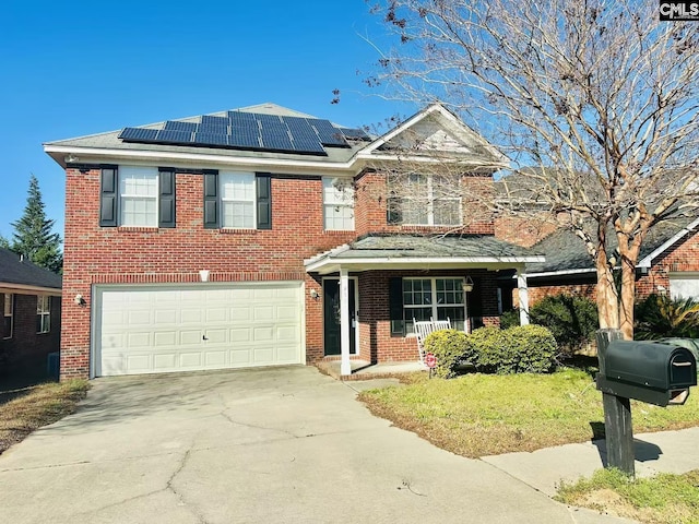 view of front of home with concrete driveway, brick siding, roof mounted solar panels, and an attached garage