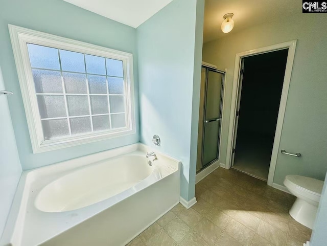 full bath with toilet, a garden tub, a shower stall, and baseboards