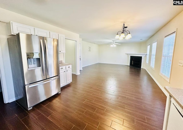 kitchen featuring dark wood-style floors, light countertops, a fireplace, and stainless steel refrigerator with ice dispenser