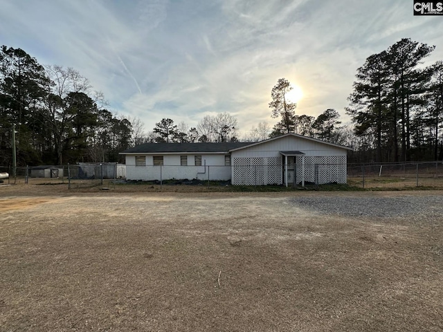 ranch-style house featuring fence