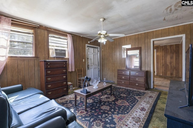 living room with ceiling fan, wooden walls, and cooling unit