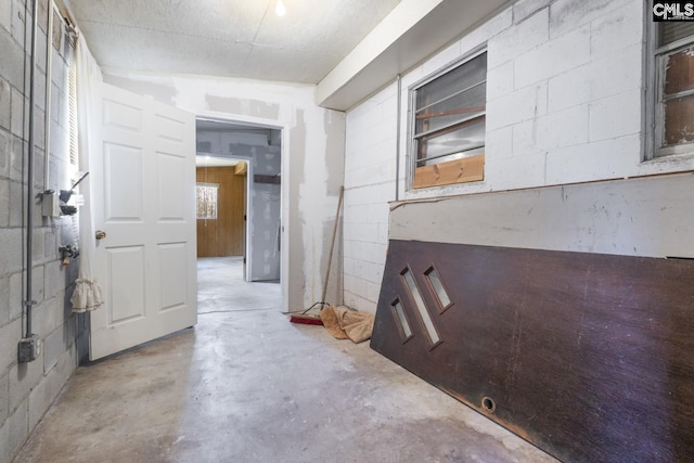 interior space with concrete block wall and concrete floors