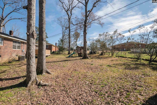 view of yard with central AC and a playground