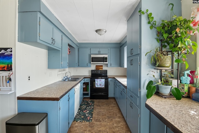 kitchen featuring stone finish flooring, black range with electric stovetop, blue cabinetry, and a sink