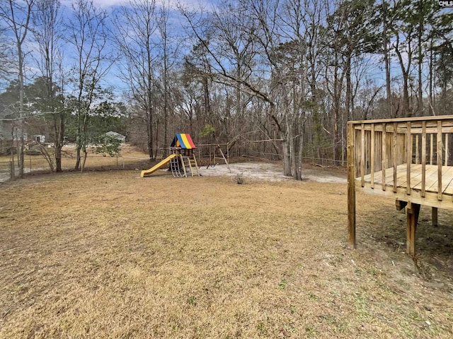 view of yard with a deck and a playground