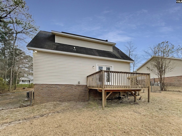 back of house featuring a deck and fence