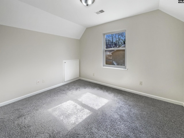 bonus room with baseboards, visible vents, and vaulted ceiling