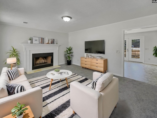 living room with a textured ceiling, a fireplace, visible vents, and baseboards