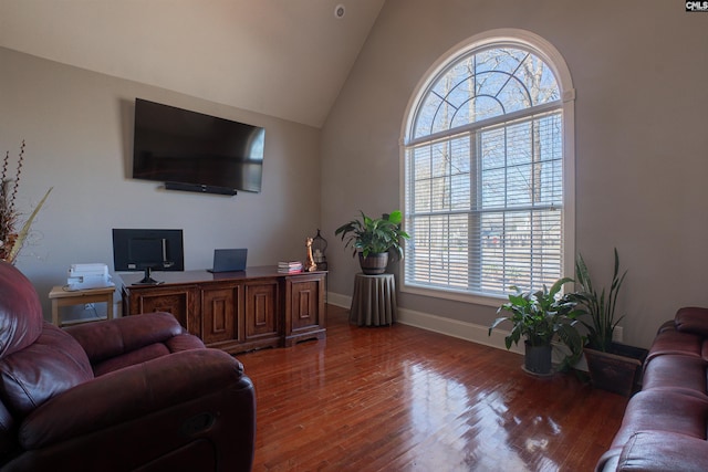 office featuring lofted ceiling, wood finished floors, and baseboards