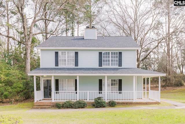 view of front of home featuring covered porch, a shingled roof, a chimney, and a front lawn