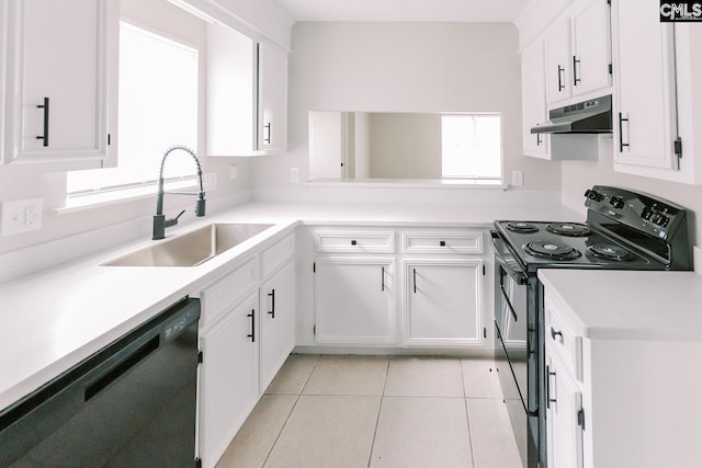 kitchen featuring light tile patterned flooring, under cabinet range hood, a sink, white cabinetry, and black appliances