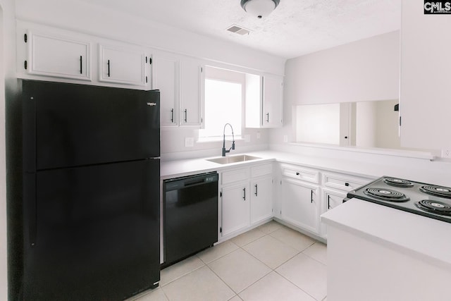 kitchen featuring light countertops, visible vents, a sink, and black appliances