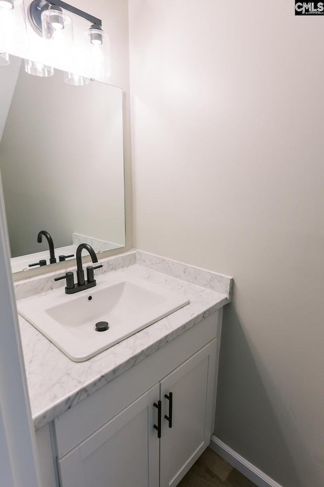 bathroom with vanity and baseboards