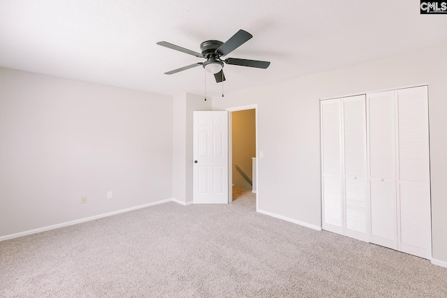 unfurnished bedroom with a ceiling fan, a closet, carpet flooring, and baseboards