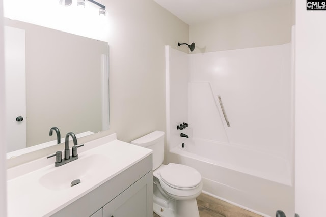 bathroom with shower / bathing tub combination, vanity, and toilet