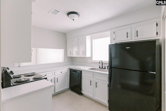 kitchen featuring visible vents, light countertops, black appliances, white cabinetry, and a sink