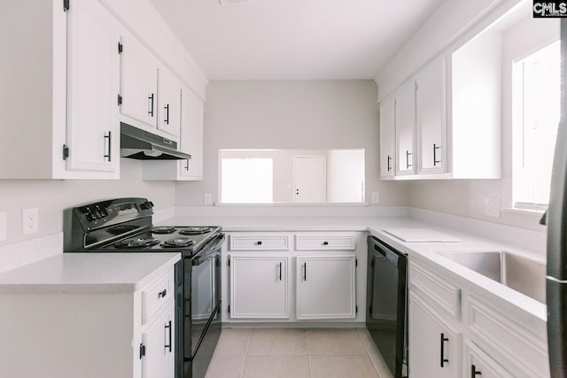 kitchen with black appliances, plenty of natural light, white cabinets, and under cabinet range hood