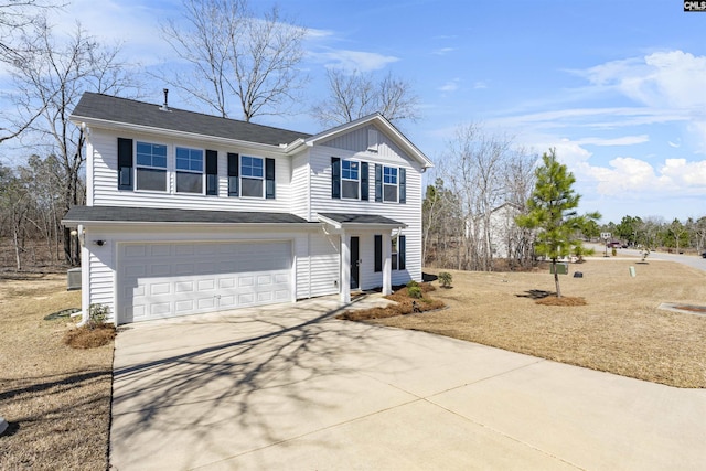 traditional-style home featuring a garage, driveway, and board and batten siding