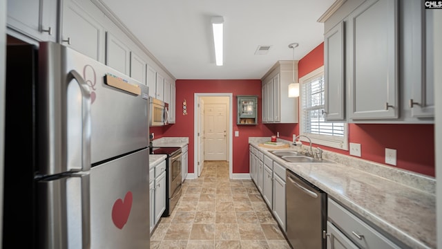 kitchen with gray cabinetry, stainless steel appliances, a sink, visible vents, and light countertops