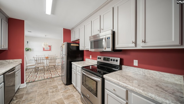 kitchen featuring baseboards and stainless steel appliances