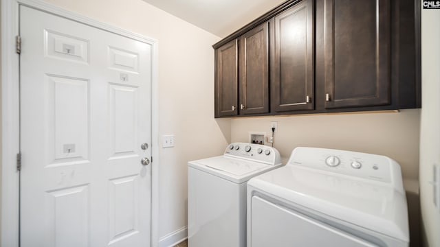 washroom featuring cabinet space and separate washer and dryer