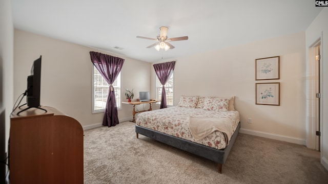 carpeted bedroom featuring visible vents, ceiling fan, and baseboards