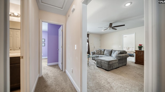 hall with carpet floors and baseboards