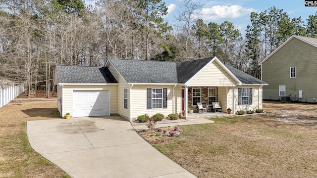 ranch-style house featuring cooling unit, a garage, a shingled roof, concrete driveway, and a front lawn