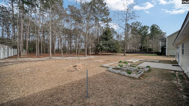 view of yard with a garden and fence