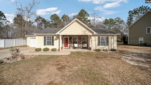 single story home featuring concrete driveway, stone siding, fence, central air condition unit, and a front yard