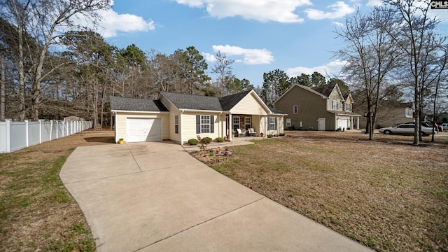 view of front facade with driveway, an attached garage, fence, and a front yard