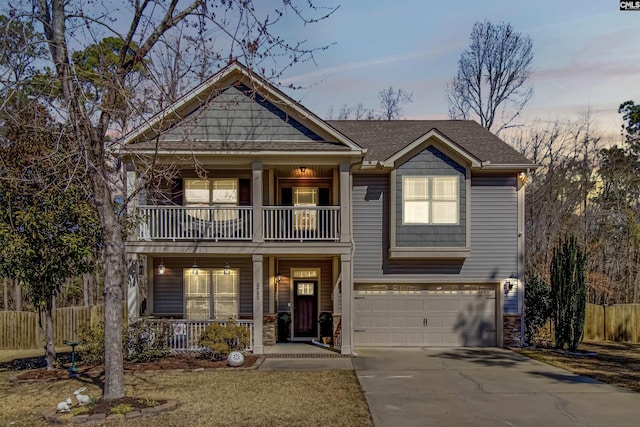 view of front of house with an attached garage, a balcony, covered porch, fence, and concrete driveway