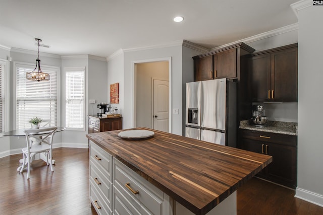 kitchen featuring a notable chandelier, wooden counters, ornamental molding, stainless steel refrigerator with ice dispenser, and dark wood finished floors