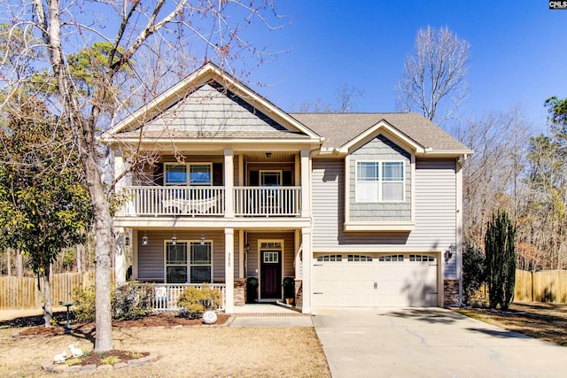 craftsman-style home featuring a porch, concrete driveway, fence, a balcony, and a garage