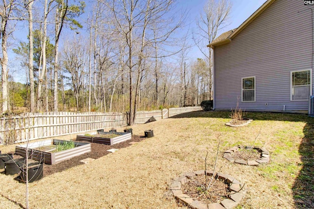 view of yard with cooling unit, a garden, and fence