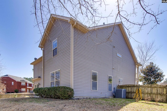 view of property exterior featuring fence and cooling unit