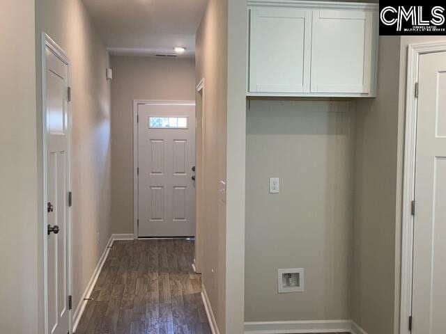 interior space featuring dark wood-style flooring and baseboards