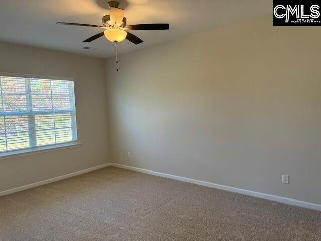 unfurnished room featuring ceiling fan, baseboards, and light colored carpet