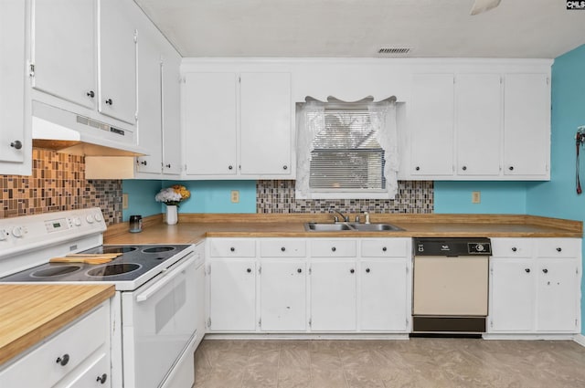 kitchen featuring white appliances, white cabinets, a sink, and under cabinet range hood