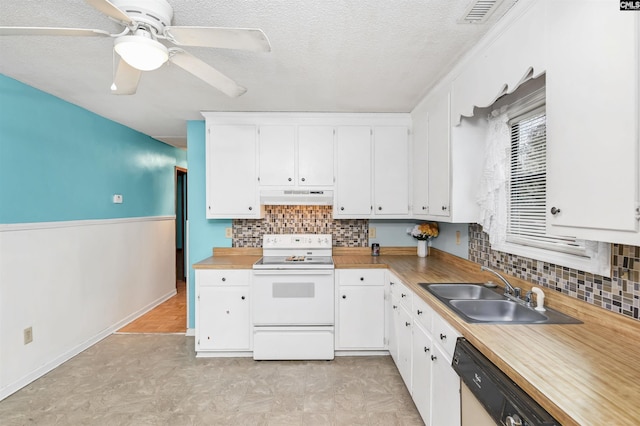 kitchen featuring white appliances, a sink, white cabinets, and under cabinet range hood