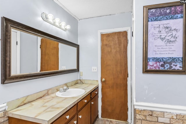 bathroom featuring a textured ceiling and vanity