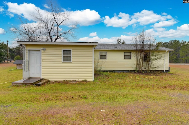 rear view of house with a yard