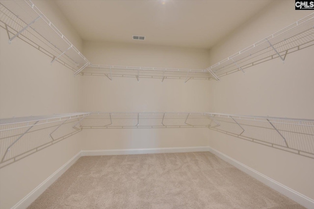 spacious closet with light carpet and visible vents