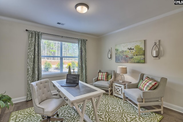 office space with wood finished floors, visible vents, and crown molding