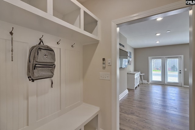 mudroom featuring recessed lighting, wood finished floors, and baseboards