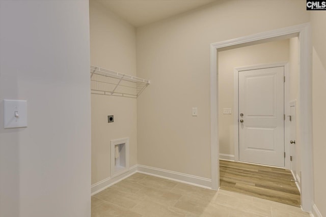 laundry room featuring laundry area, baseboards, light wood finished floors, and hookup for an electric dryer